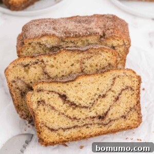 Three slices of cinnamon swirled snickerdoodle bread, showcasing its inviting texture.