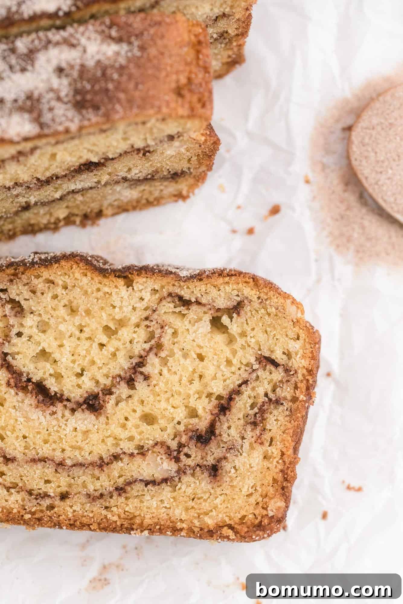 Delicious loaf of Snickerdoodle Bread served with a side of cinnamon sugar.
