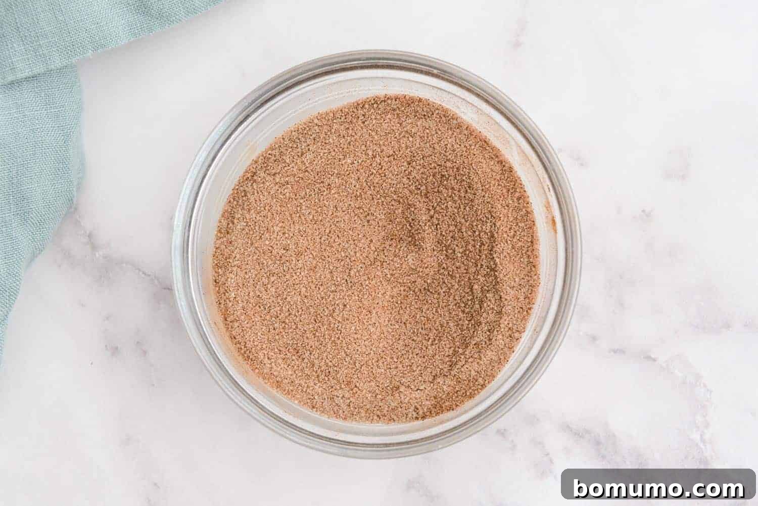 A glass bowl filled with the fragrant cinnamon sugar mixture, ready for baking.