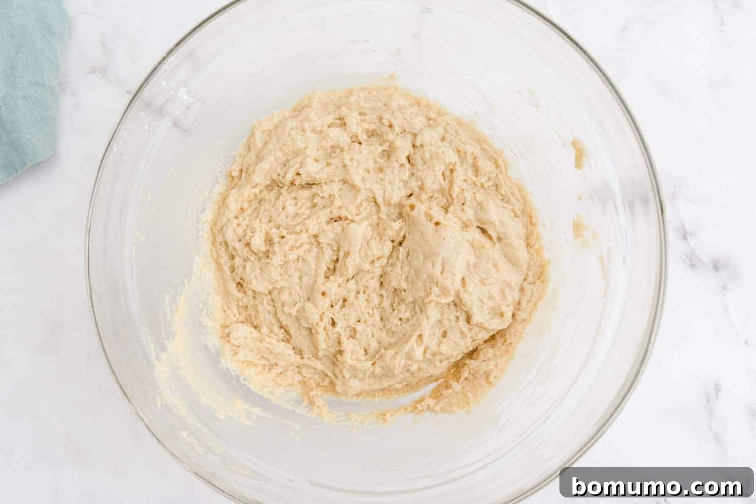 Smooth and perfectly mixed bread batter in a clear glass bowl, ready for layering.