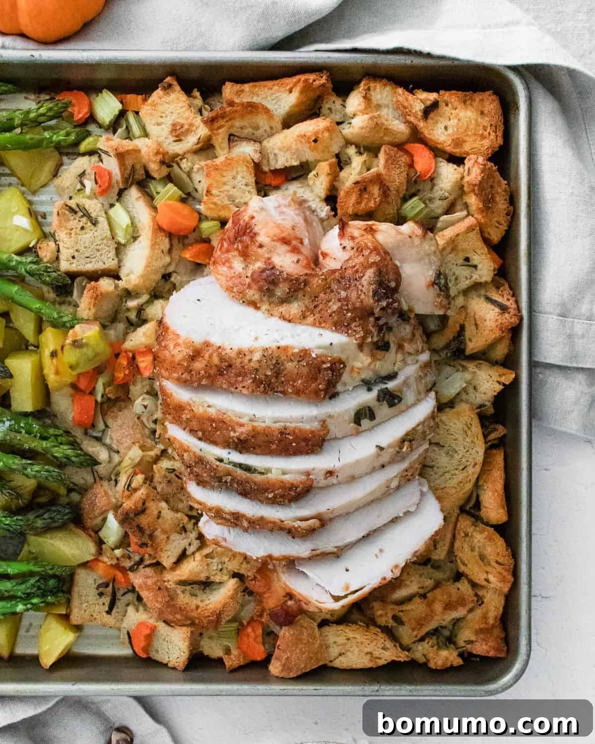 Turkey breast placed on top of stuffing.