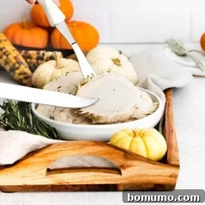 Sliced turkey breast with a knife and fork.