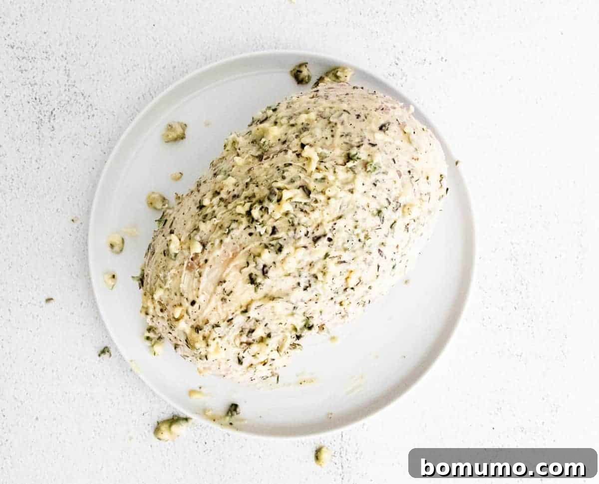 Turkey breast covered with butter and herbs.