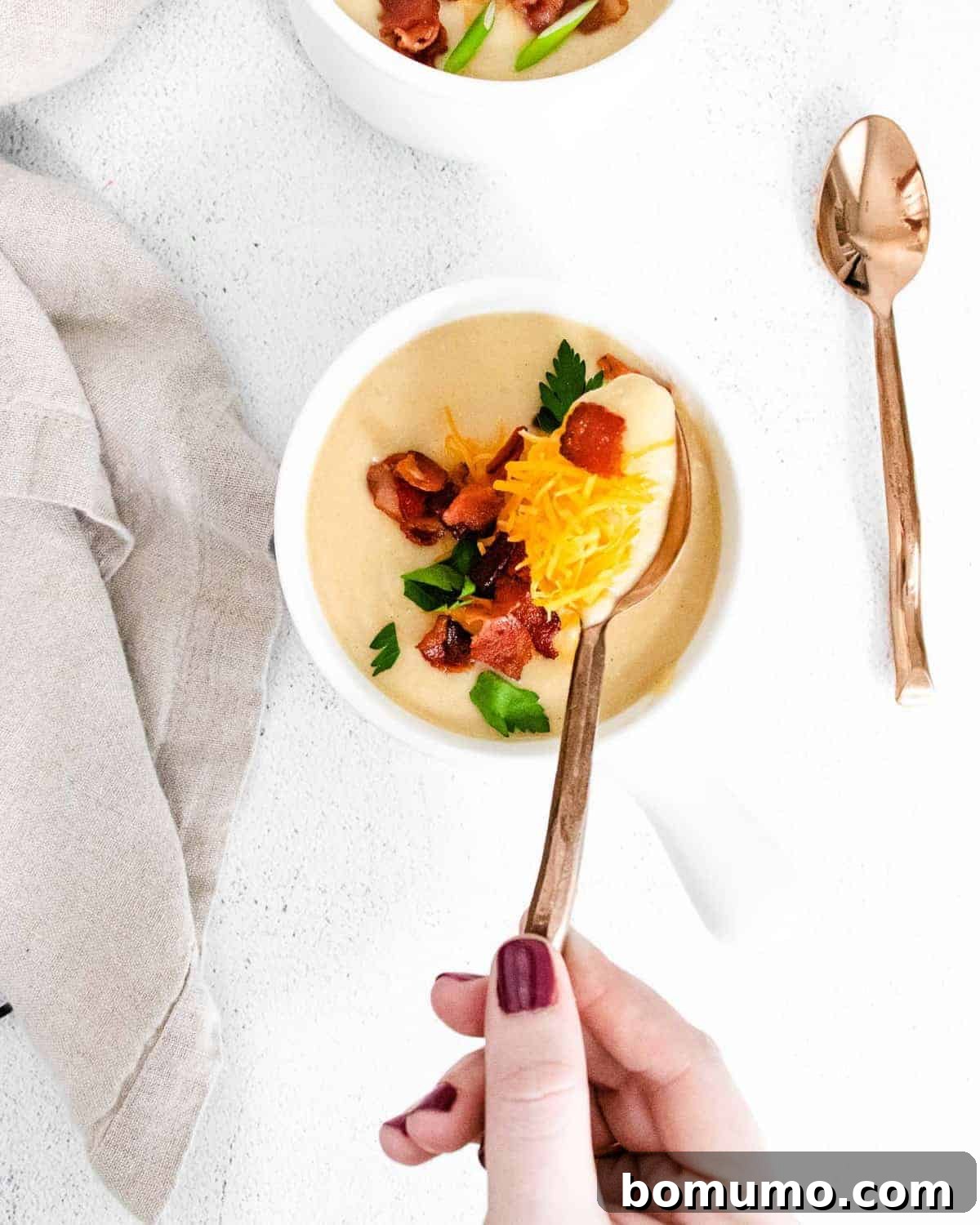 Creamy soup in a bowl and on a spoon.