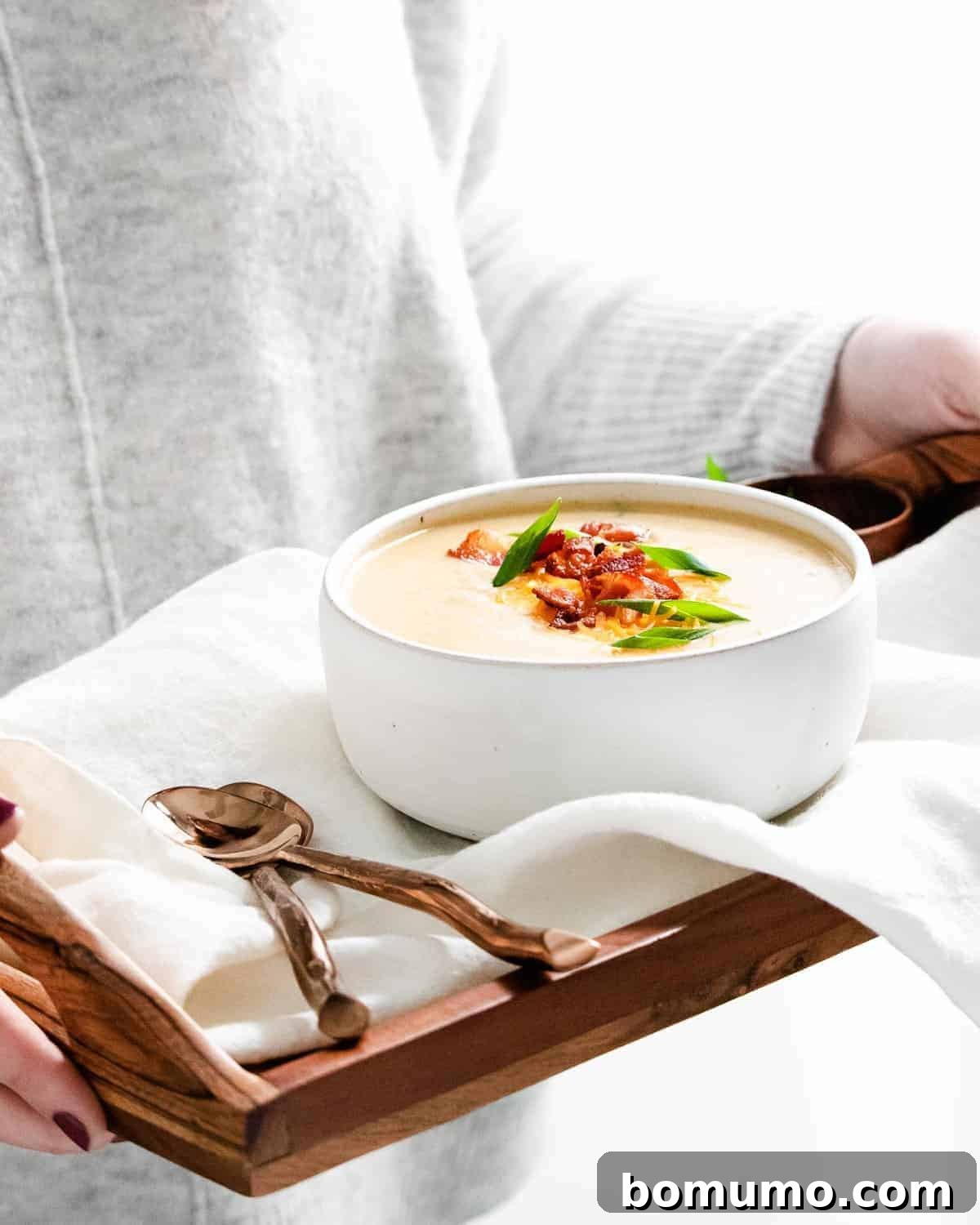 Soup on a tray with spoons.