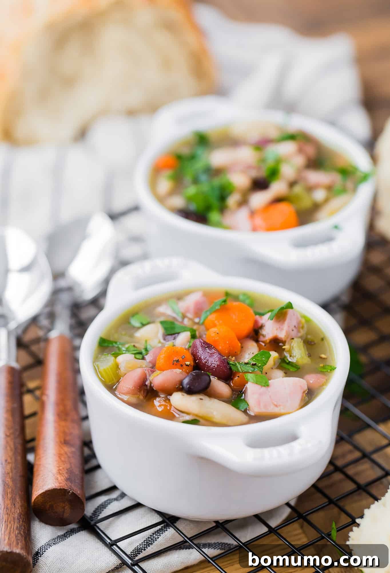 Bean soup with carrots, ham, celery, herbs.
