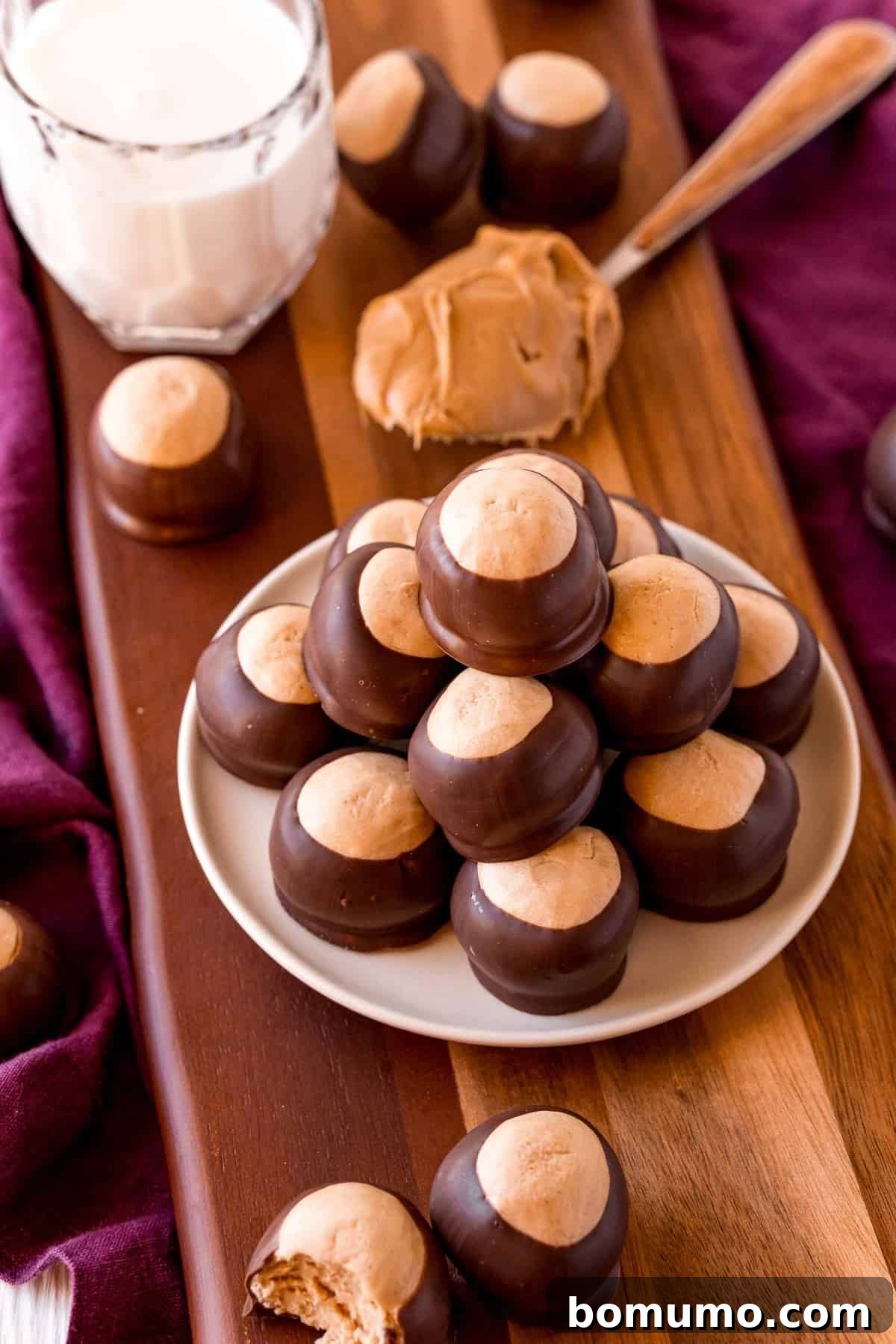 A delightful display of finished buckeyes on a plate, with ingredients subtly blurred in the background.
