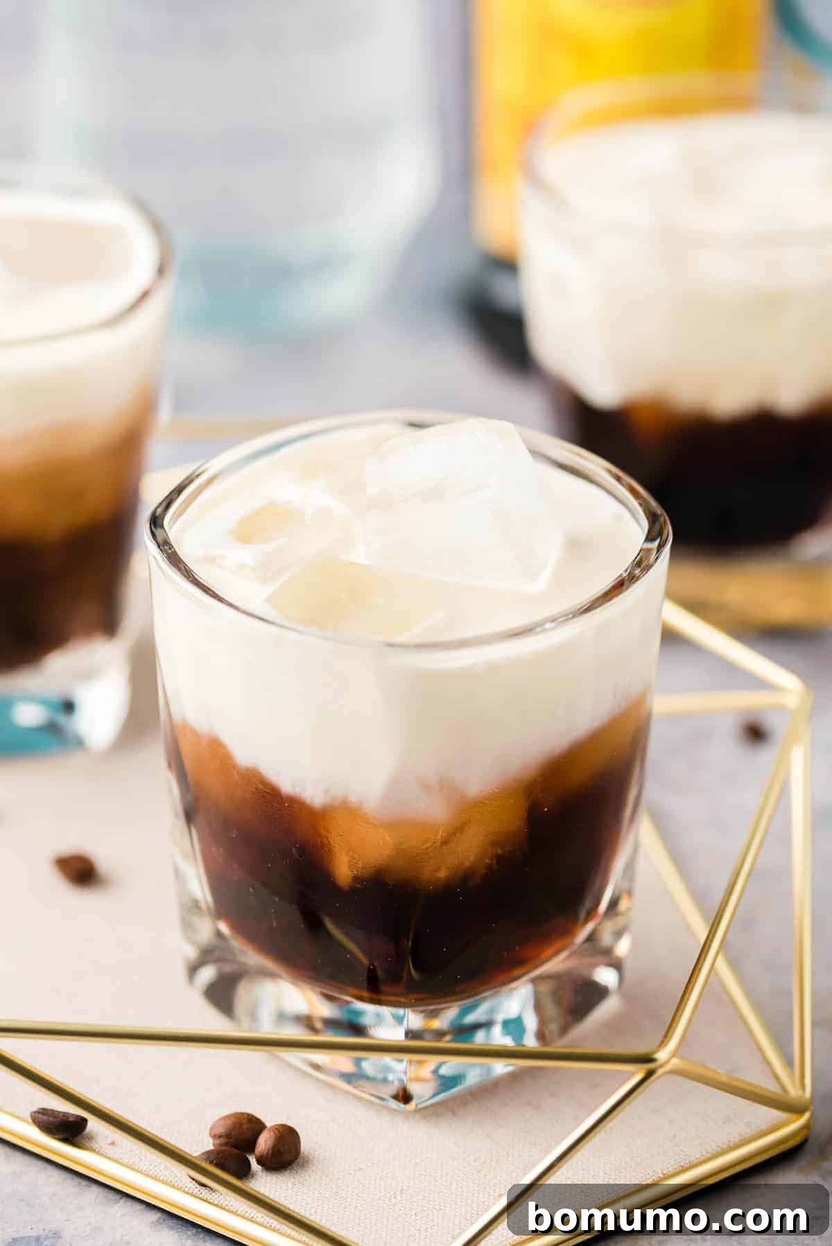 Brown and white cocktail on a tray.