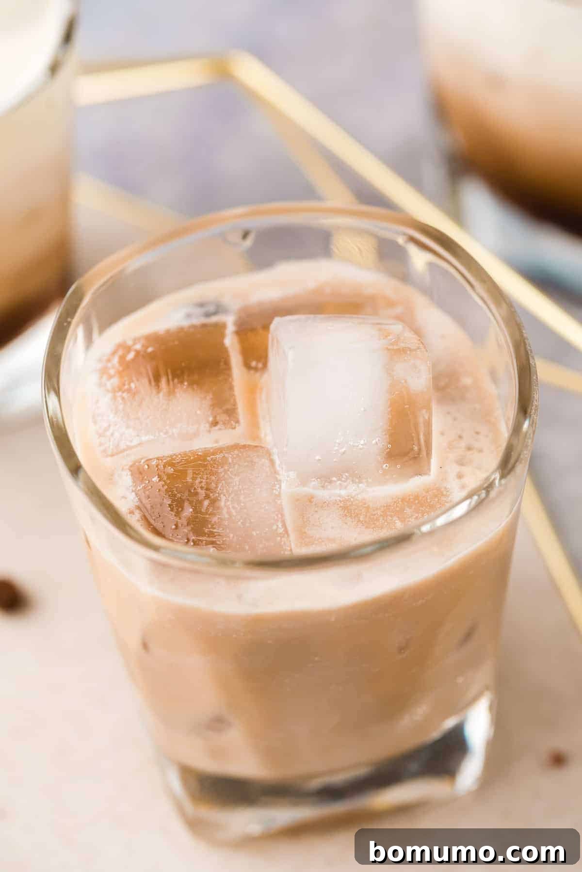 Light brown drink on ice.