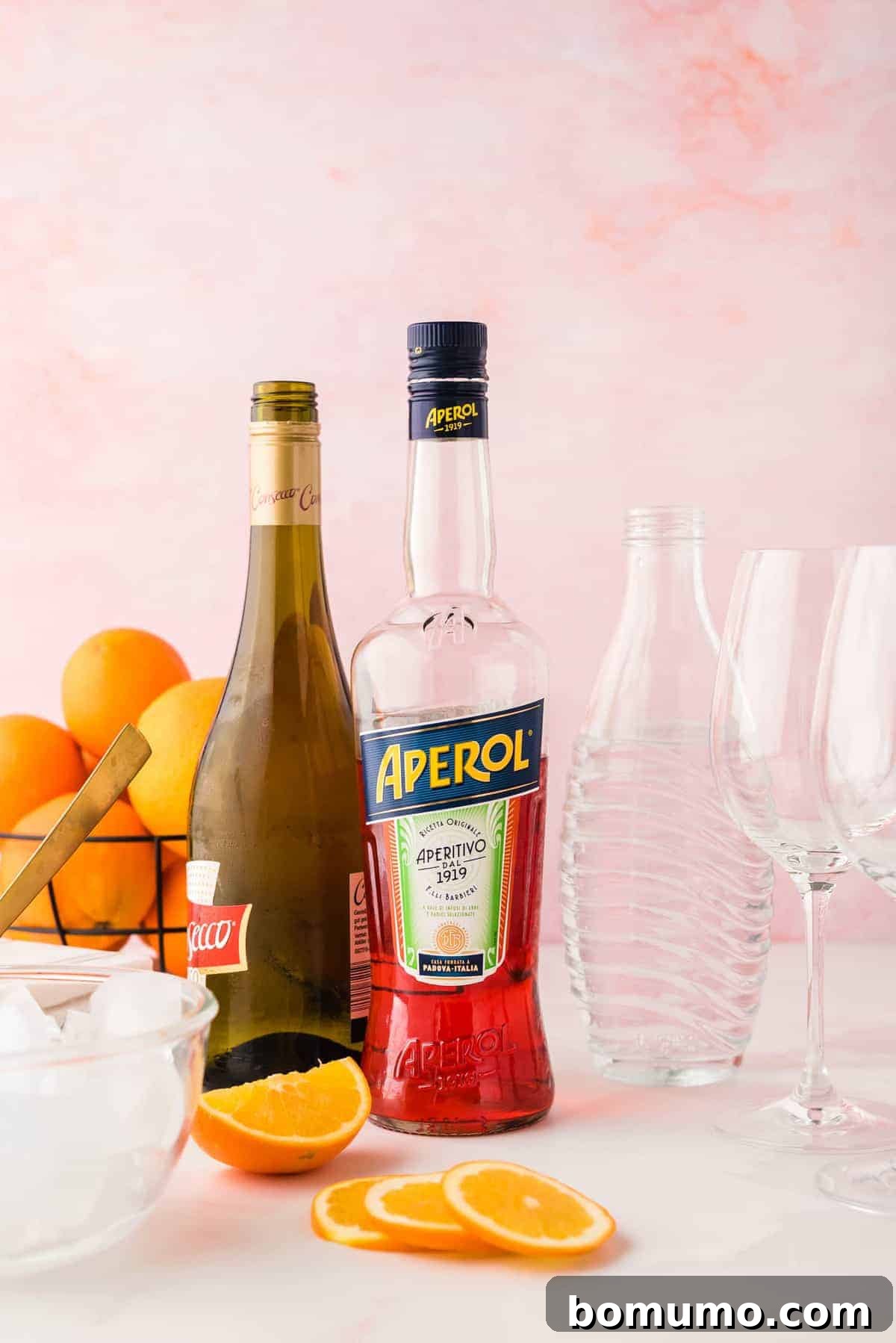 Mastering The Aperol Spritz 5 The three essential ingredients for an Aperol Spritz: Aperol, Prosecco, and sparkling water, neatly arranged for preparation.