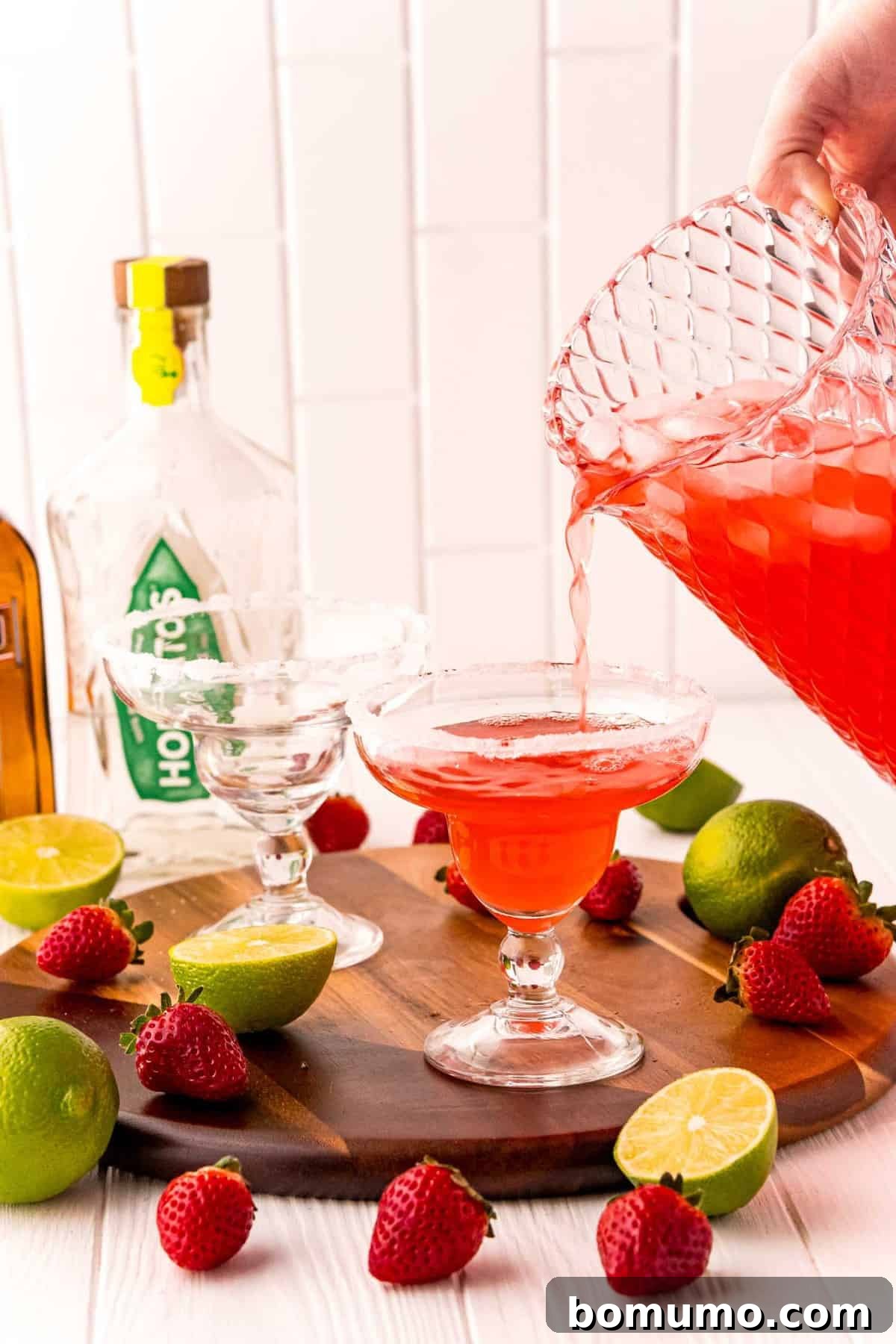 Punch being poured into a margarita glass.