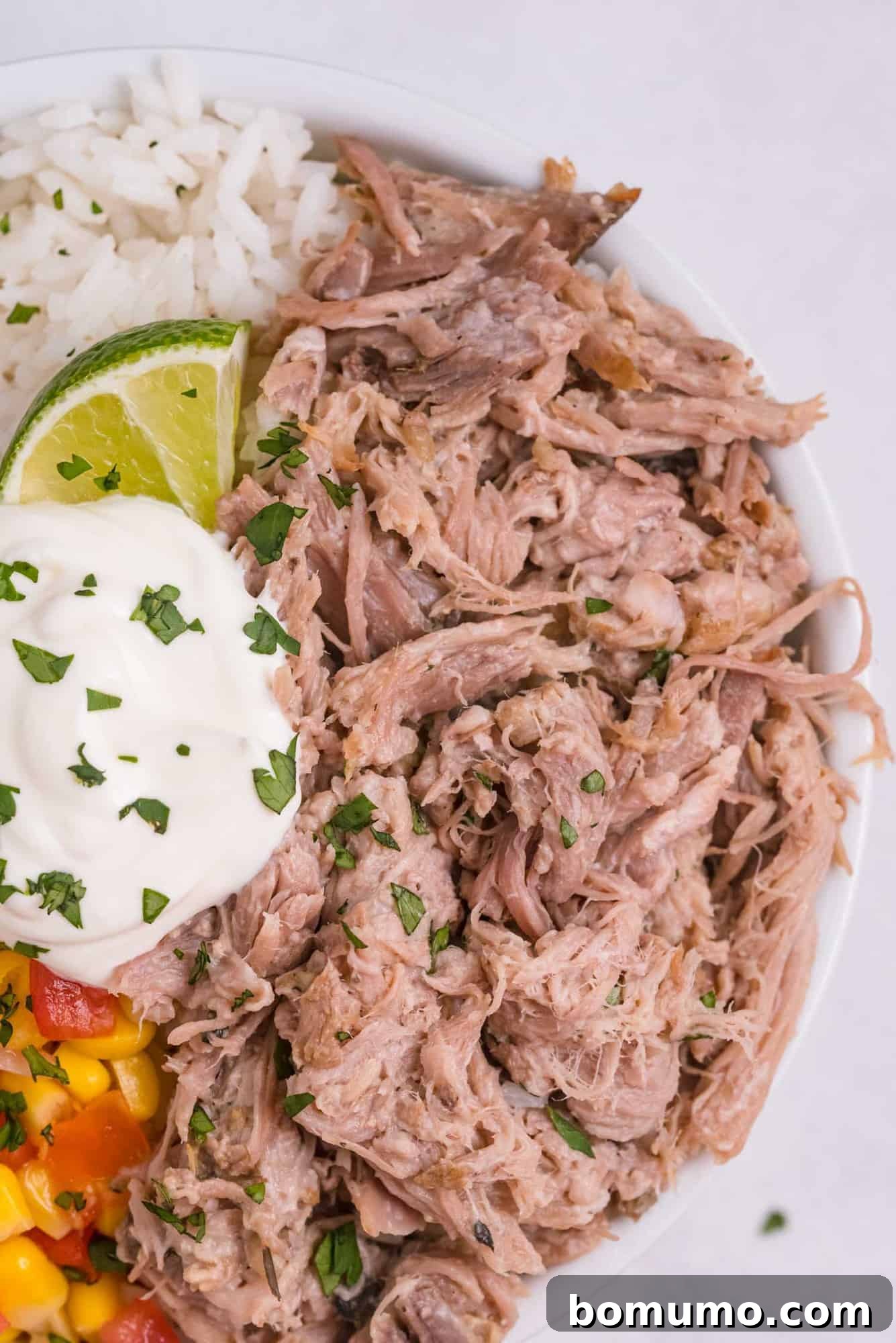 Close-up of succulent shredded Slow Cooker Cuban Pork, highlighting its tender texture and rich, savory color, ready for any meal.