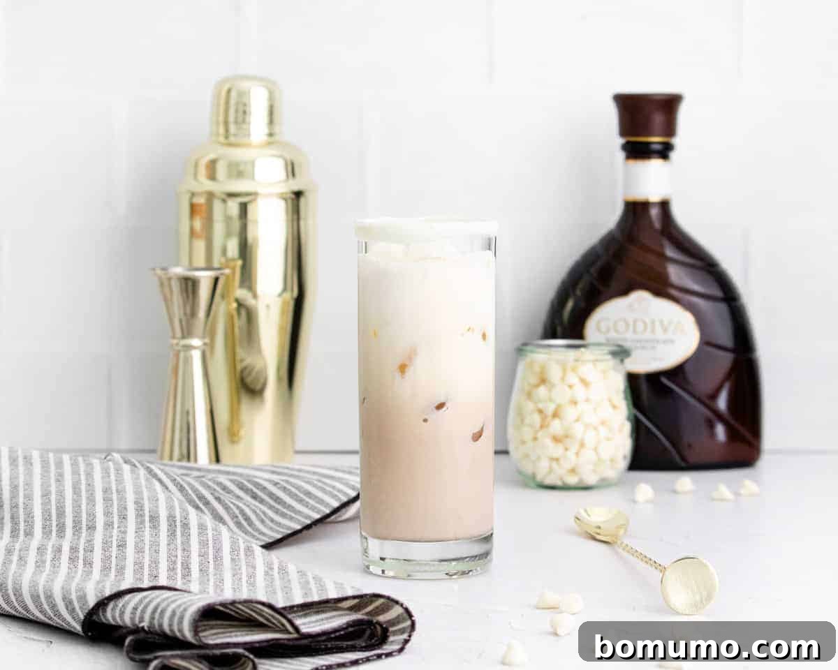 A beautifully arranged cocktail scene featuring a White Chocolate White Russian in a glass, surrounded by its key ingredients and a shaker, ready for preparation.