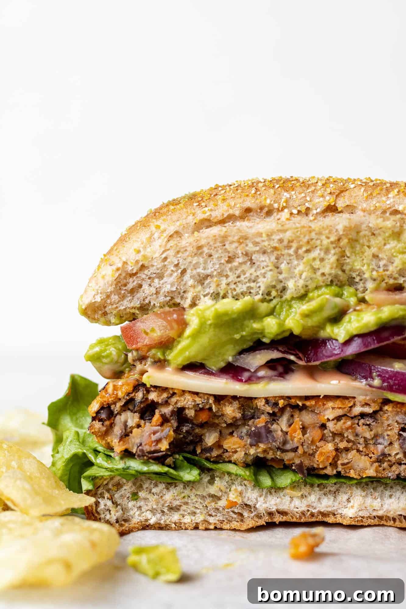Savory Black Bean Bliss 12 A perfectly baked black bean burger, expertly cut in half to reveal its appealing, firm, and flavorful internal texture.