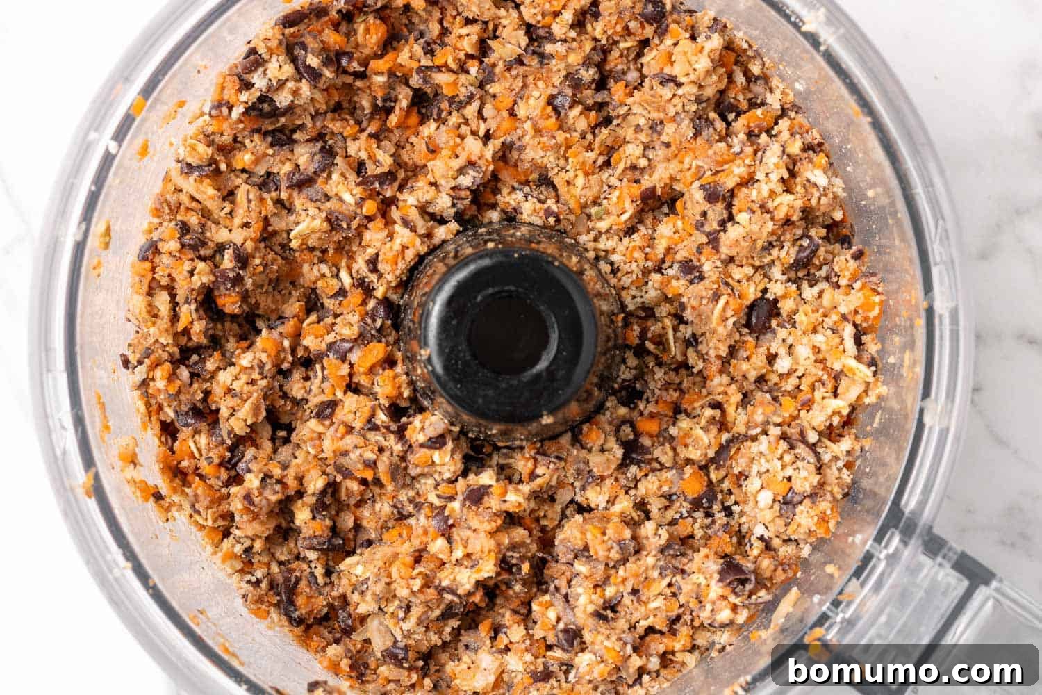 Savory Black Bean Bliss 8 The black bean burger mixture, perfectly chunky and seasoned, ready for forming into patties in a food processor bowl.