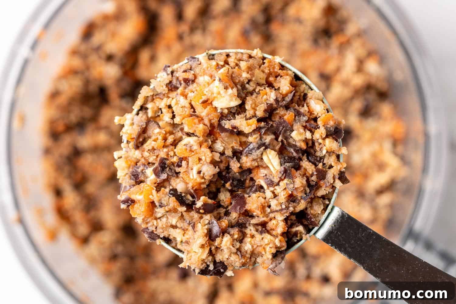 Savory Black Bean Bliss 9 Unformed black bean burger mixture measured into a half-cup, demonstrating the ideal portion size before shaping.