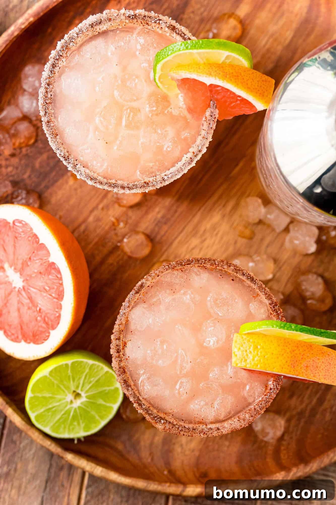 Overhead view of two paloma cocktails served on ice.