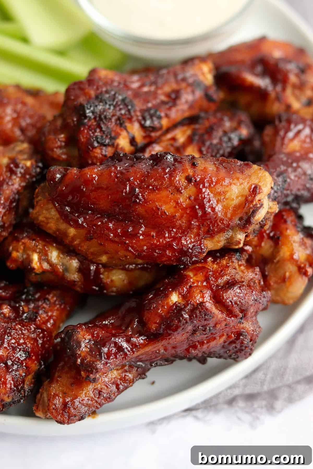 Air fried chicken wings coated in bbq sauce.