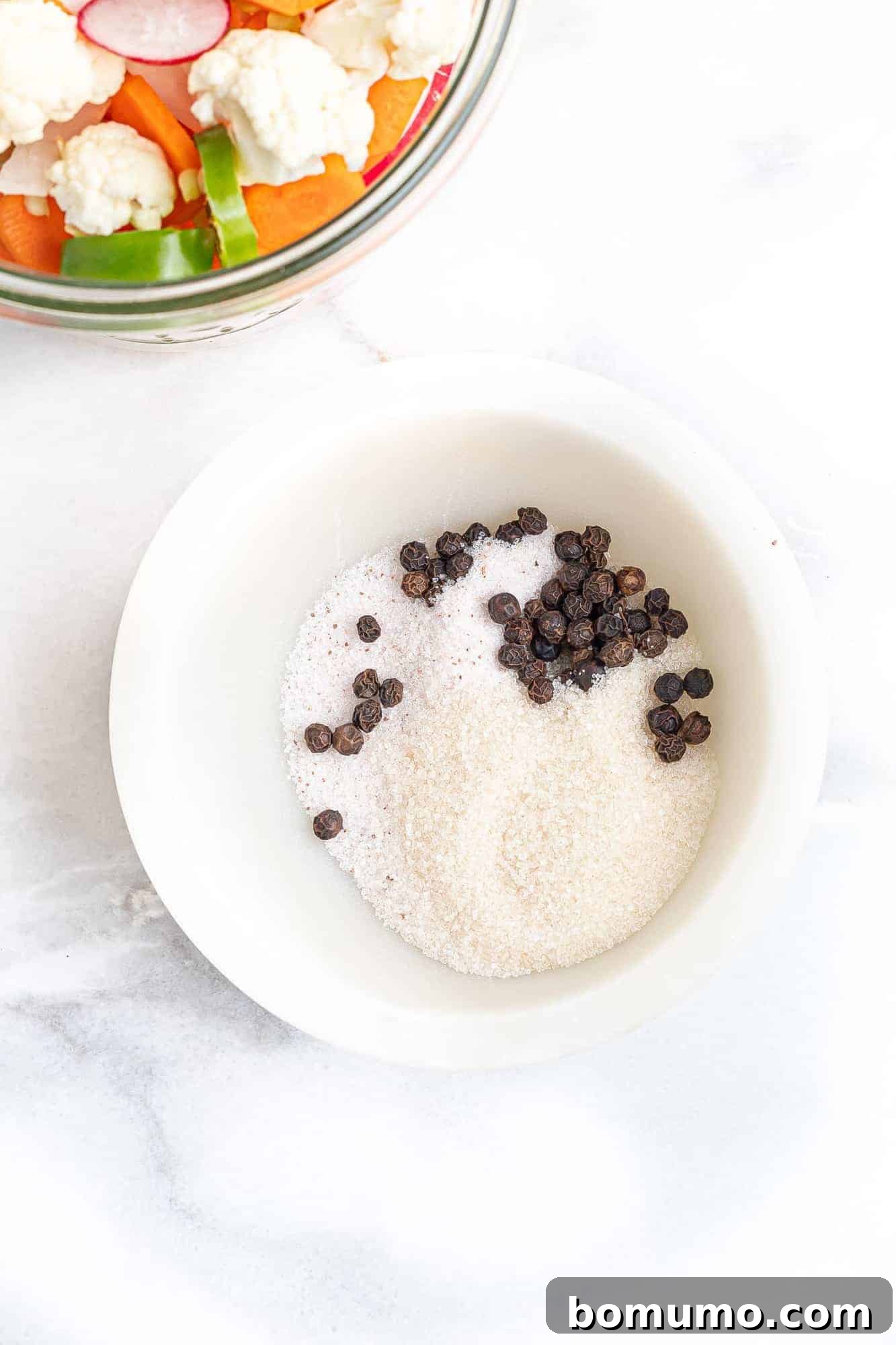 Sugar, salt, and peppercorns in a small bowl, ready for the pickling brine.