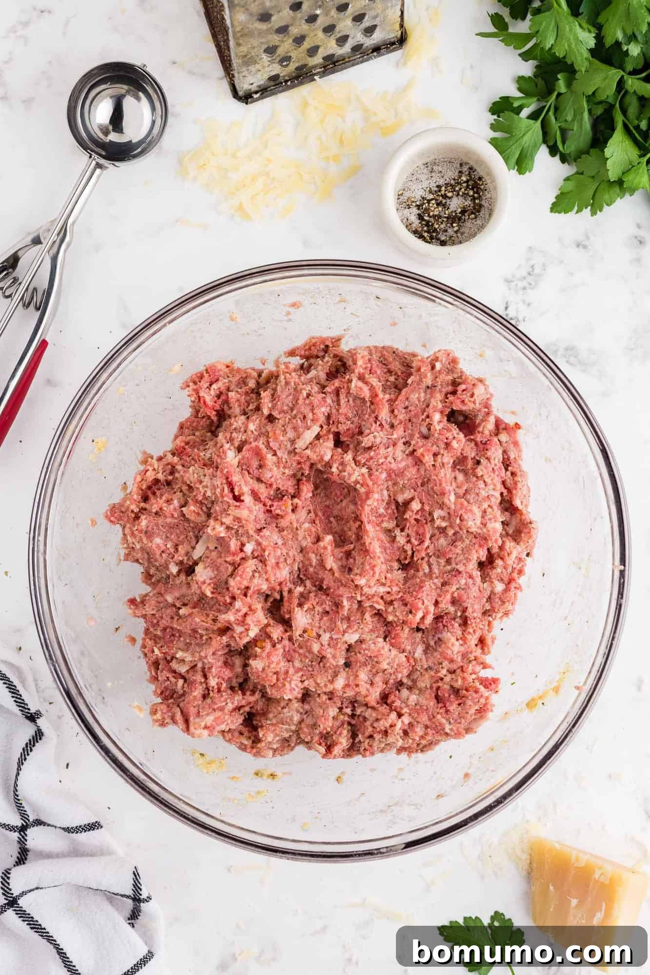 Ground meat and spices fully mixed together in a bowl, ready for shaping.