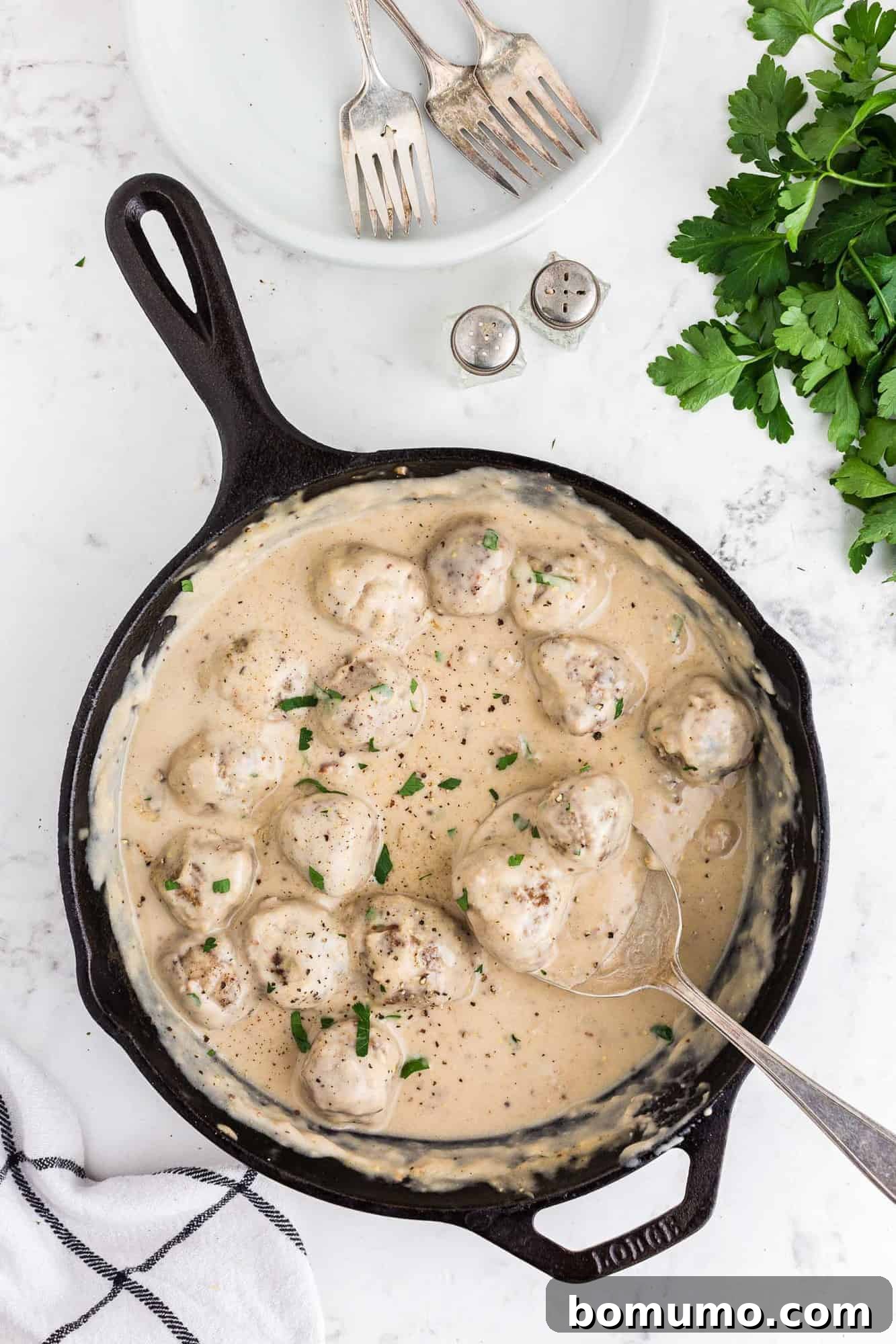 Swedish meatballs in a black cast iron pan.