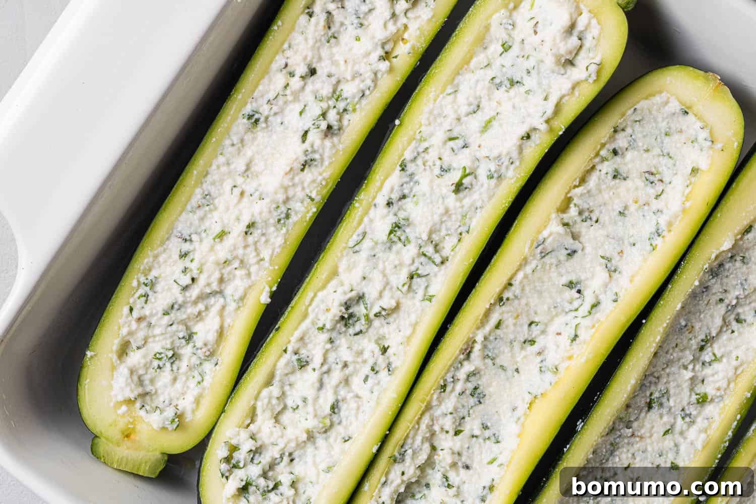 Zucchini halves stuffed with ricotta mixture.