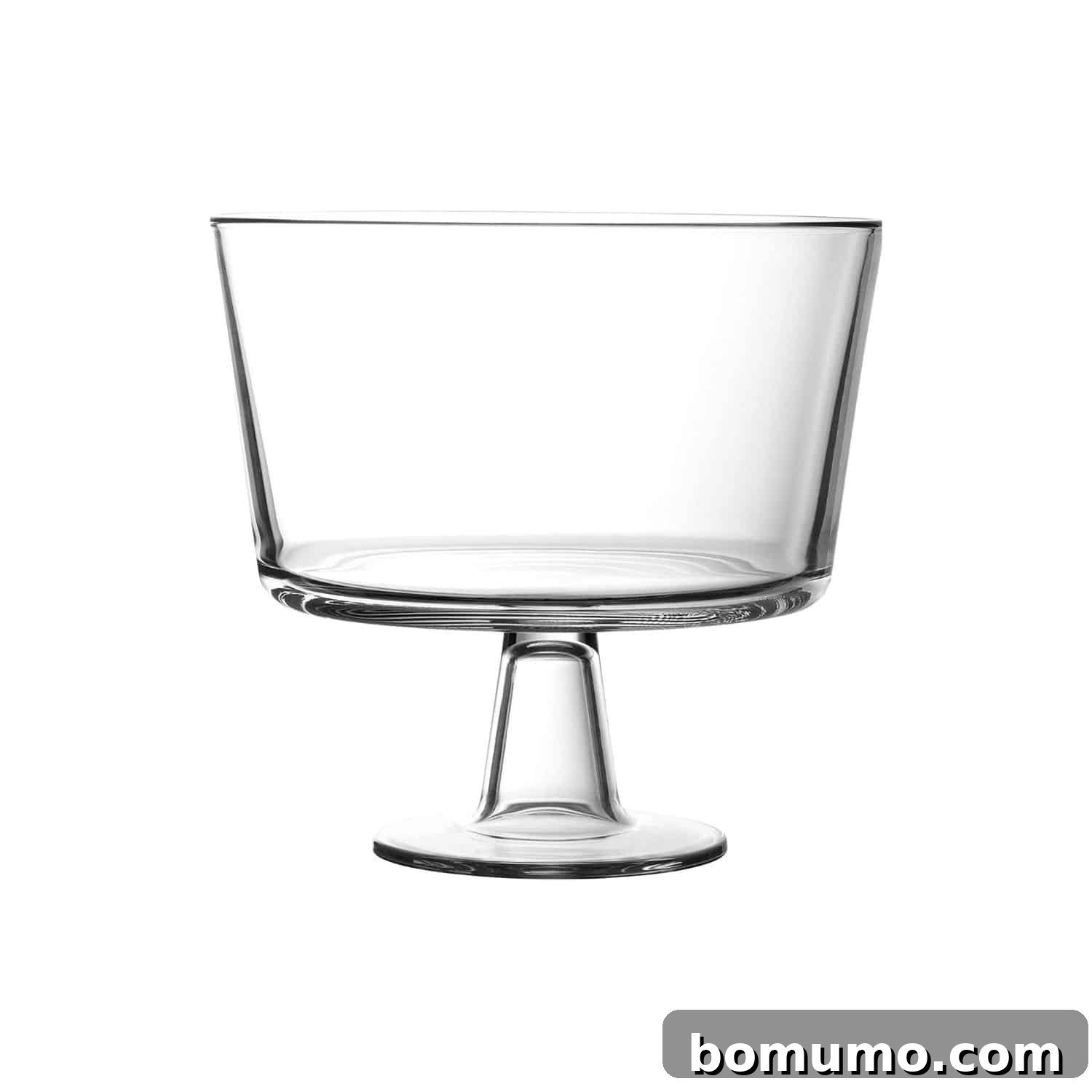 Empty clear glass trifle bowl on a light surface, ready to be filled with delicious layers.