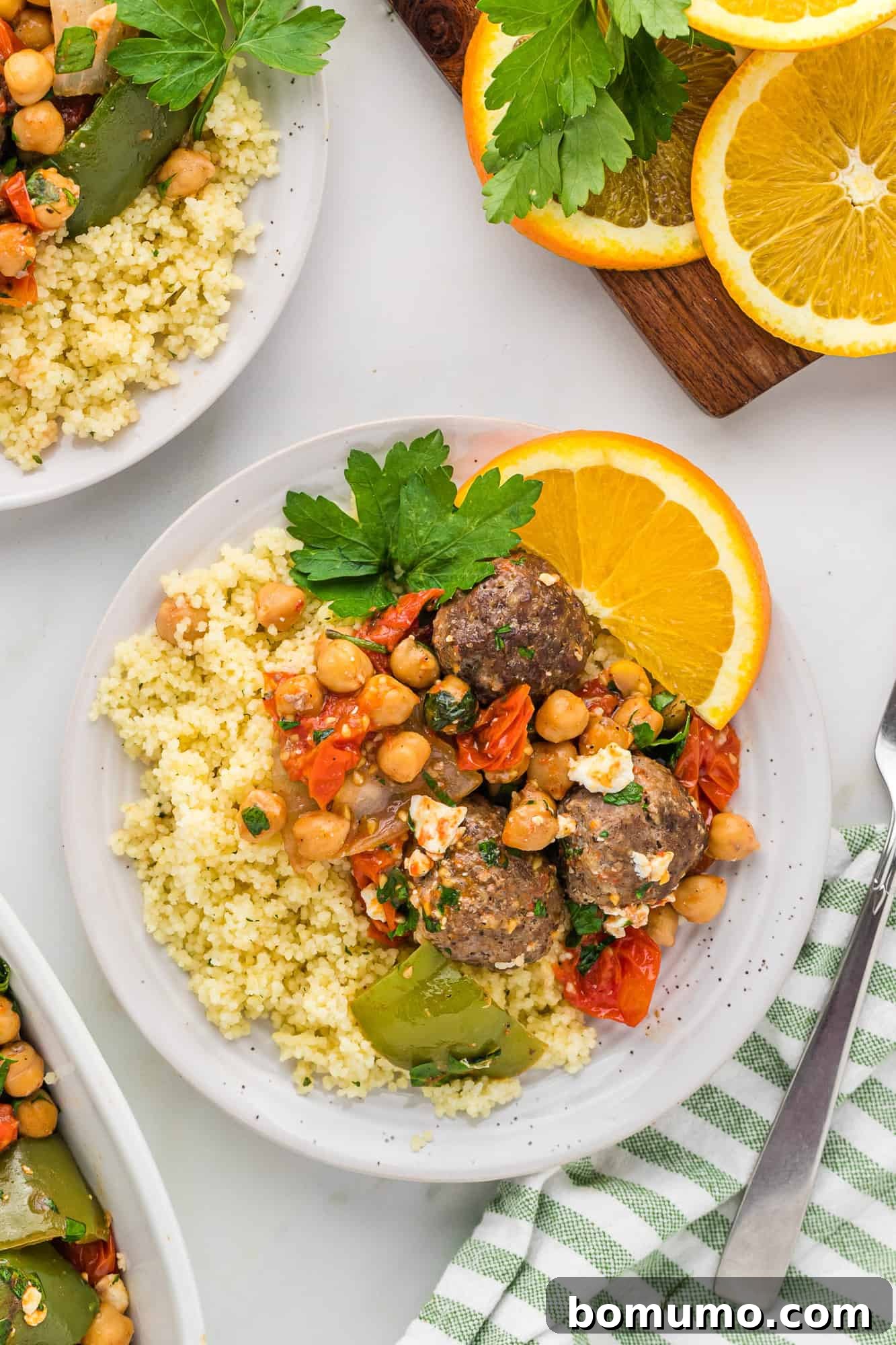 Plated Moroccan meatballs with chickpeas and tomatoes, ready to serve.
