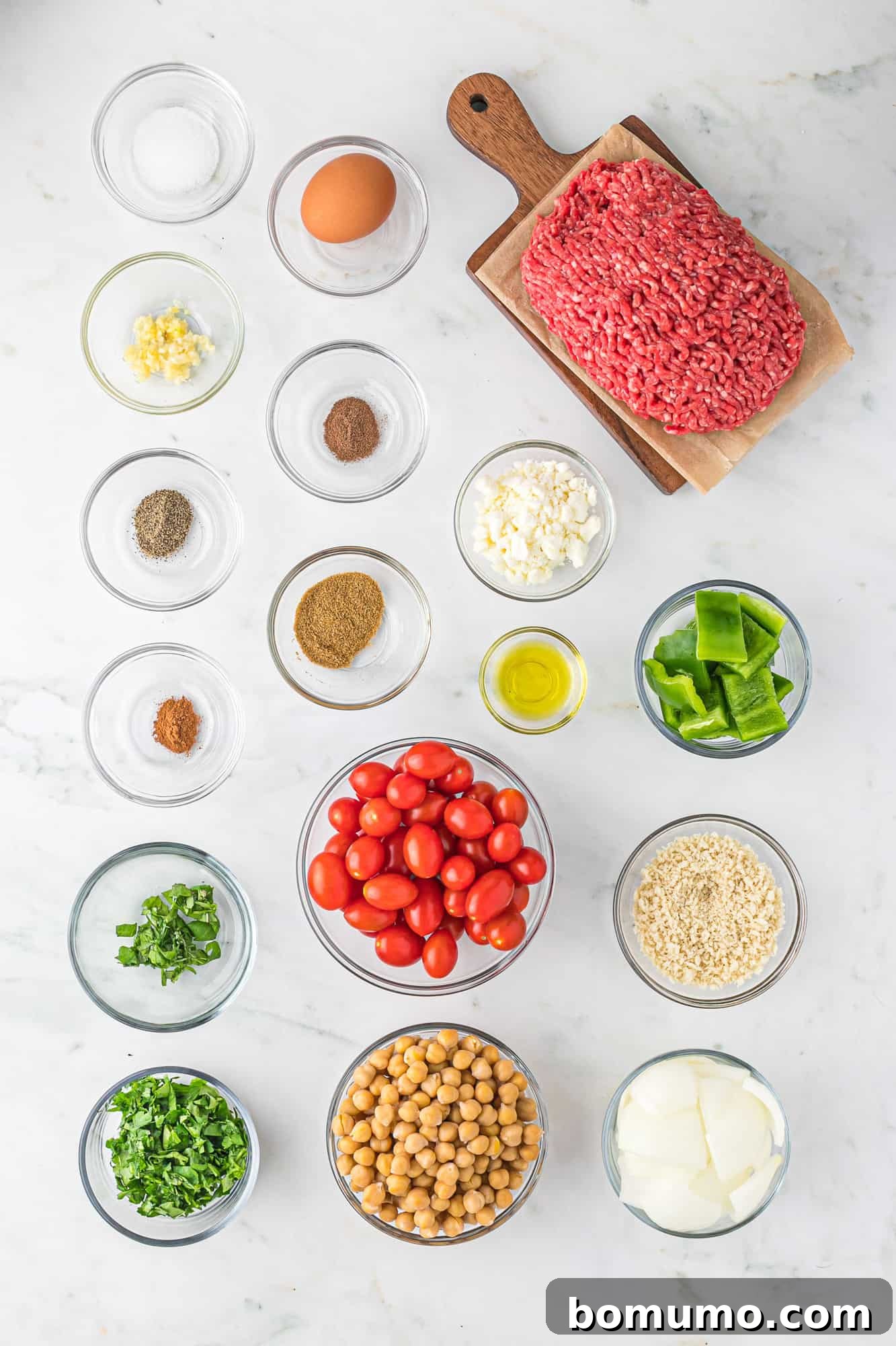 Overhead view of all fresh ingredients neatly laid out on a table, ready for cooking.