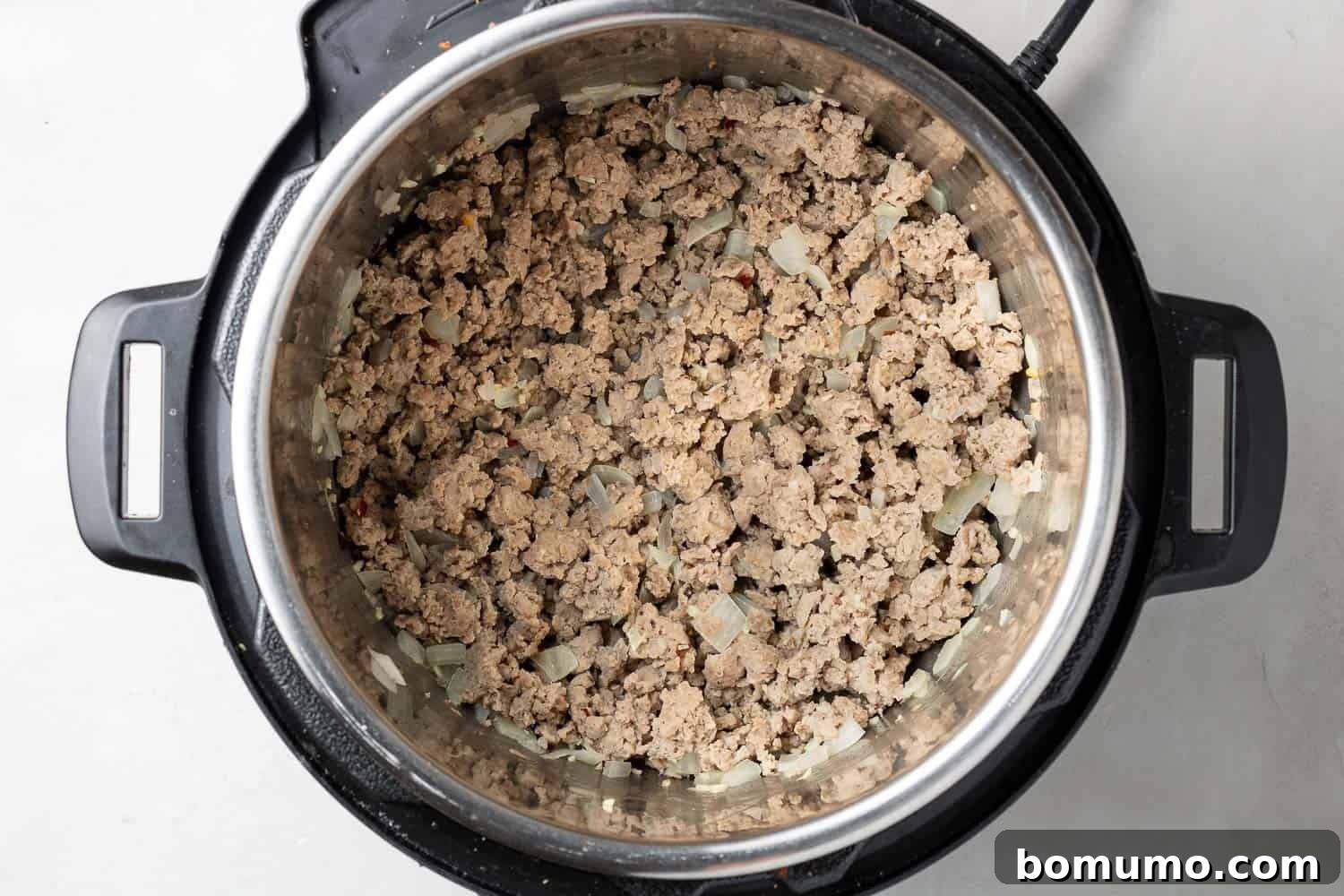 Browned ground chicken in an Instant Pot.