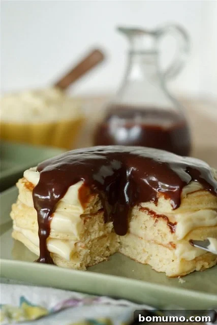 Closeup front view of pancakes with wedge removed.