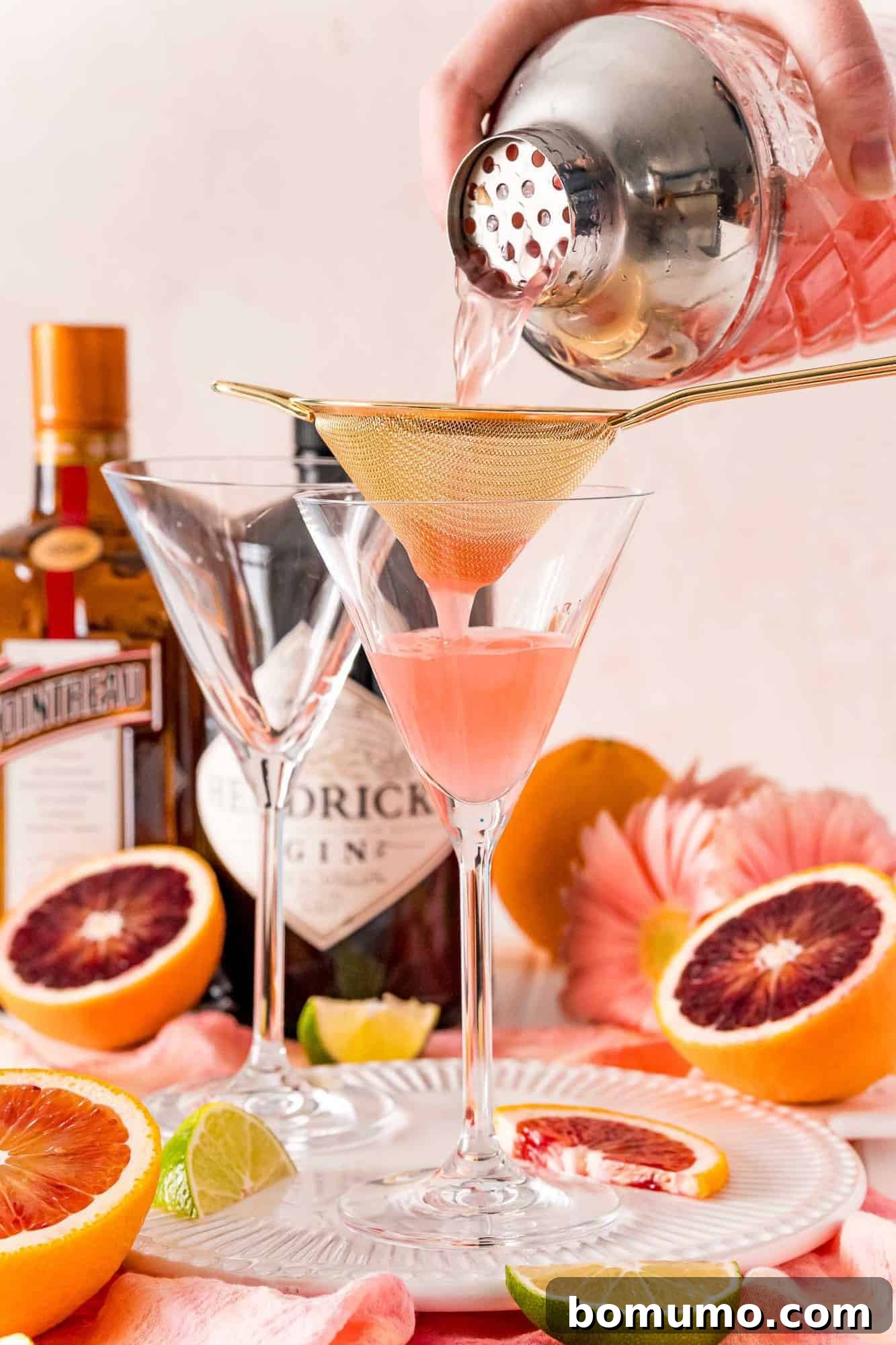 Blood Moon Martini 6 A perfectly mixed martini being strained from a shaker into an elegant martini glass, ensuring a smooth pour.
