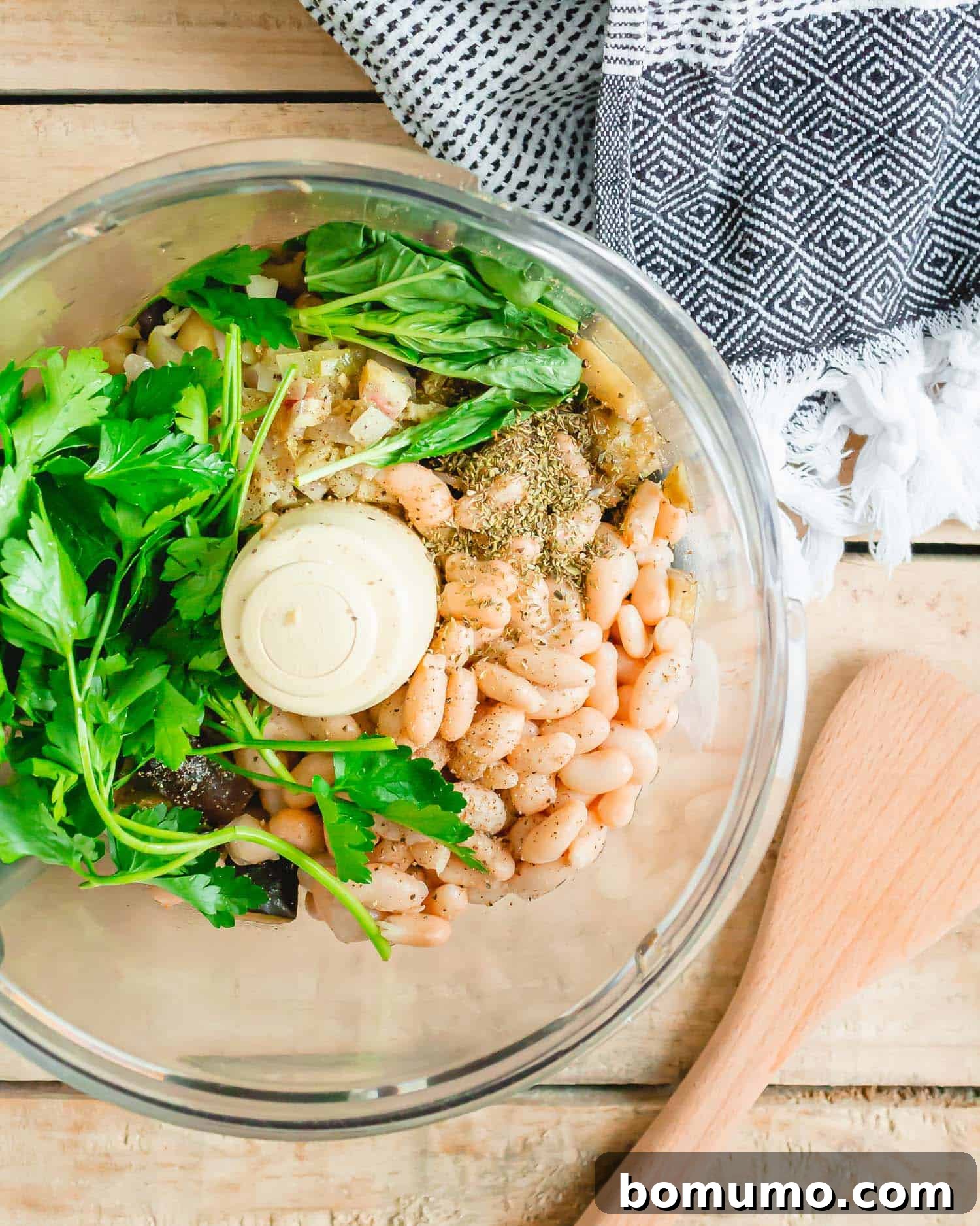 Beans, herbs, and sautéed eggplant in a food processor.