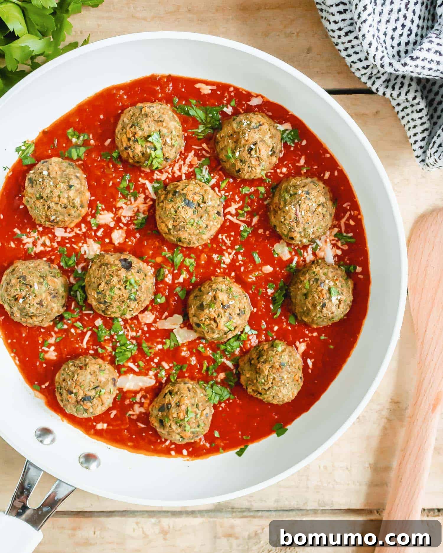 Meatballs and sauce in a frying pan.