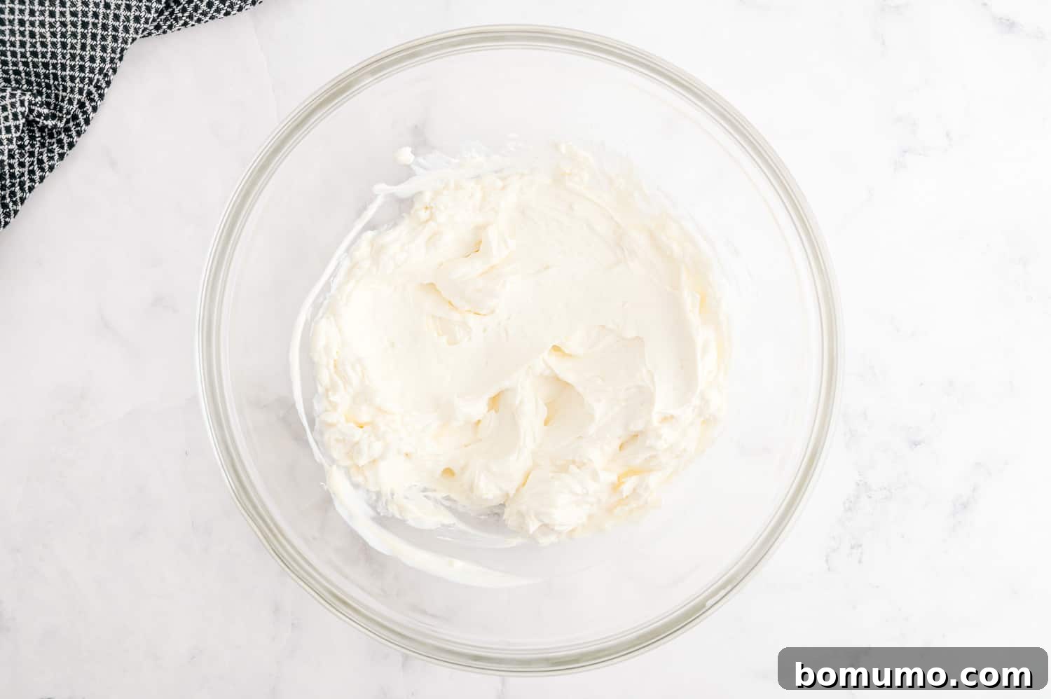 Creamy ingredients in a glass mixing bowl.