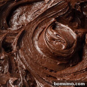 Close up of chocolate buttercream frosting, swirled to show texture.
