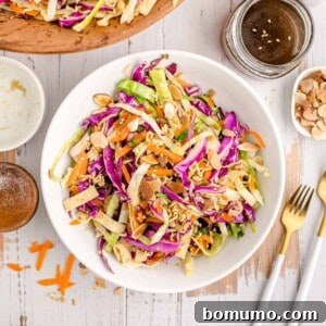 Overhead view of Asian style salad in a white bowl, ready to be enjoyed.