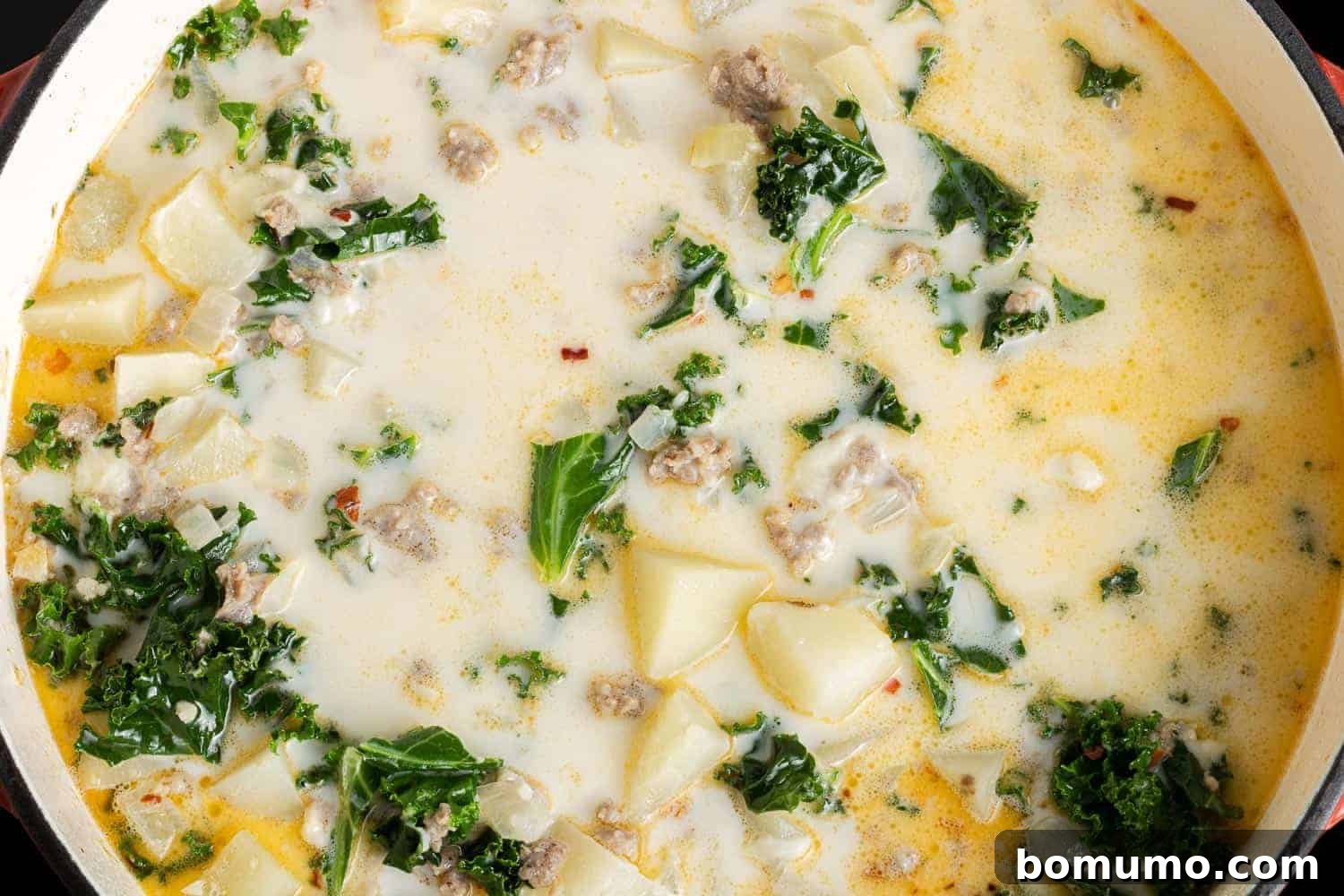 A rich, creamy Zuppa Toscana, beautifully blended with tender kale, hearty potatoes, and savory Italian sausage, ready to be served.