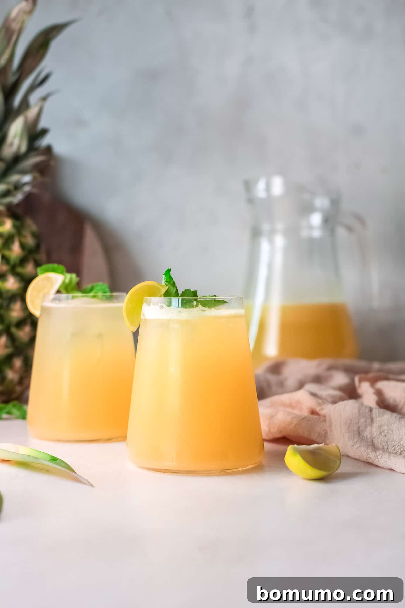 Pineapple Agua Fresca 2 Light yellow drink with a pineapple in the background, signaling freshness and natural ingredients.