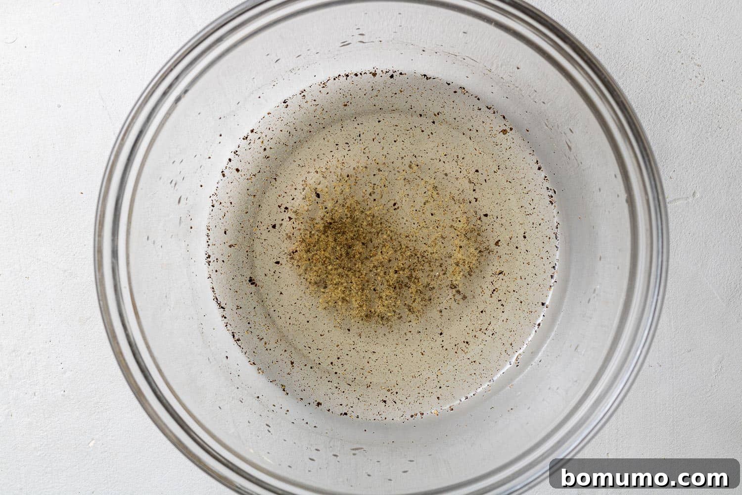 Dressing for cucumber salad in a small bowl.