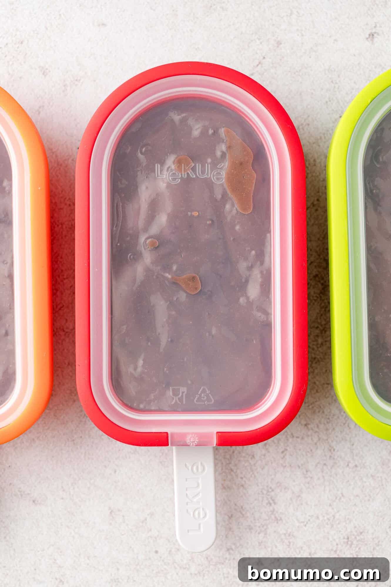 Popsicle molds with lids securely in place, ready for freezing.