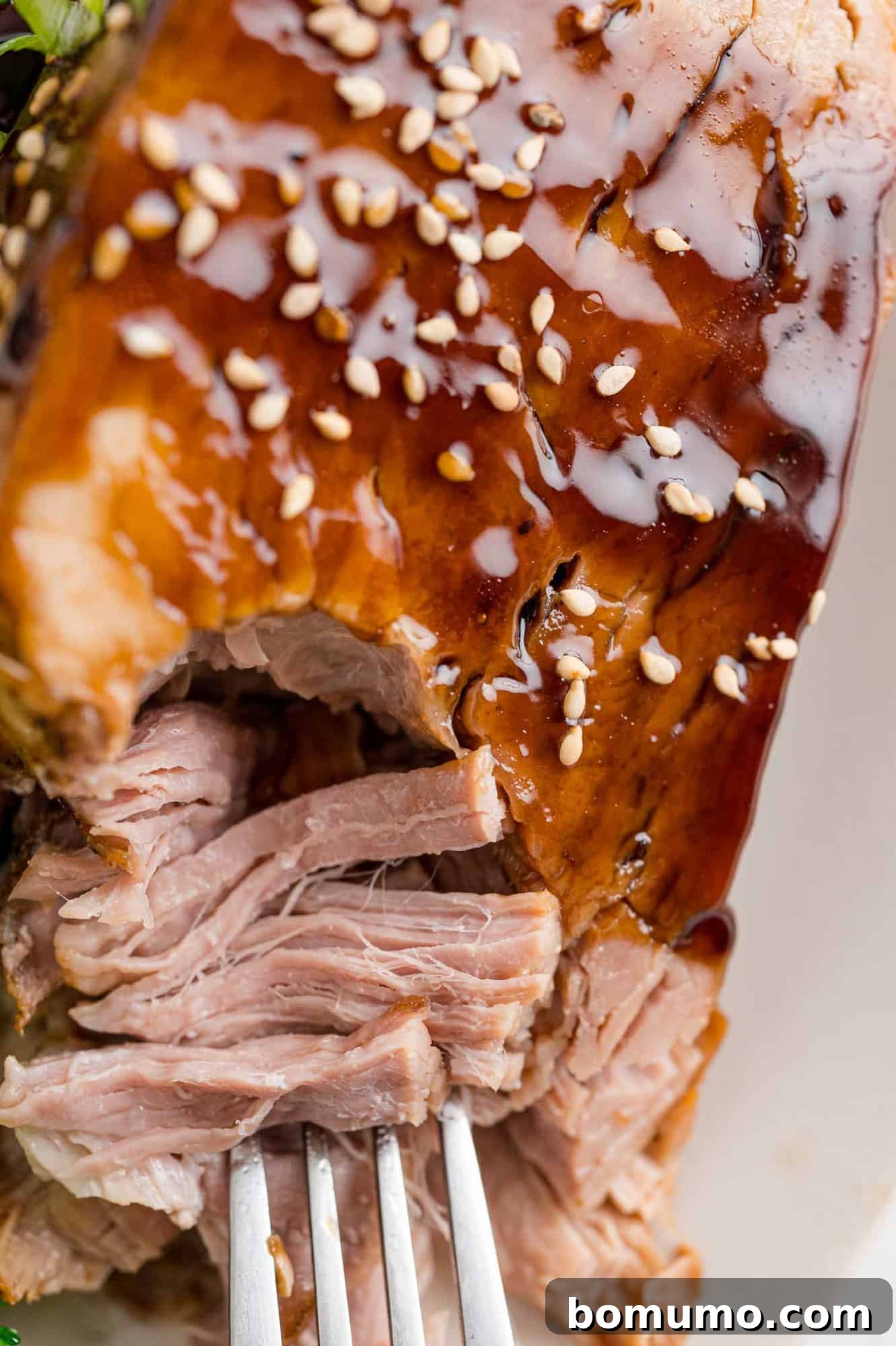Close-up of tender slow cooker pork loin slices, showing their juiciness.
