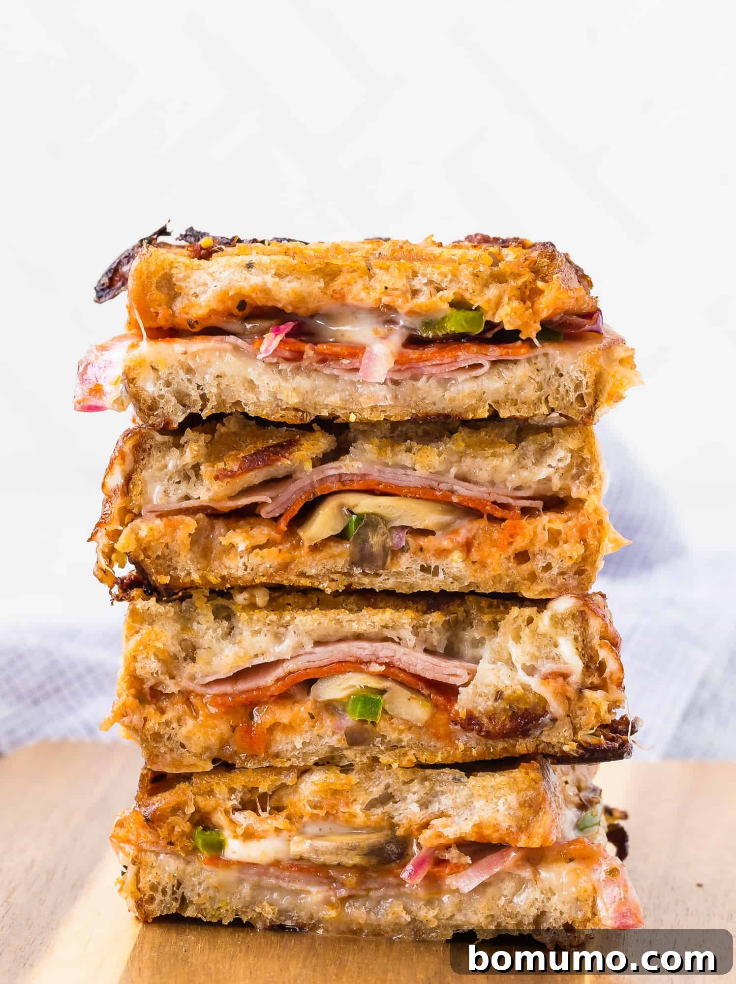 Grilled Pizza Panini 4 Grilled sandwiches with abundant pizza fillings and melted cheese, ready to serve.