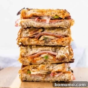 Stack of pizza paninis cut in half.