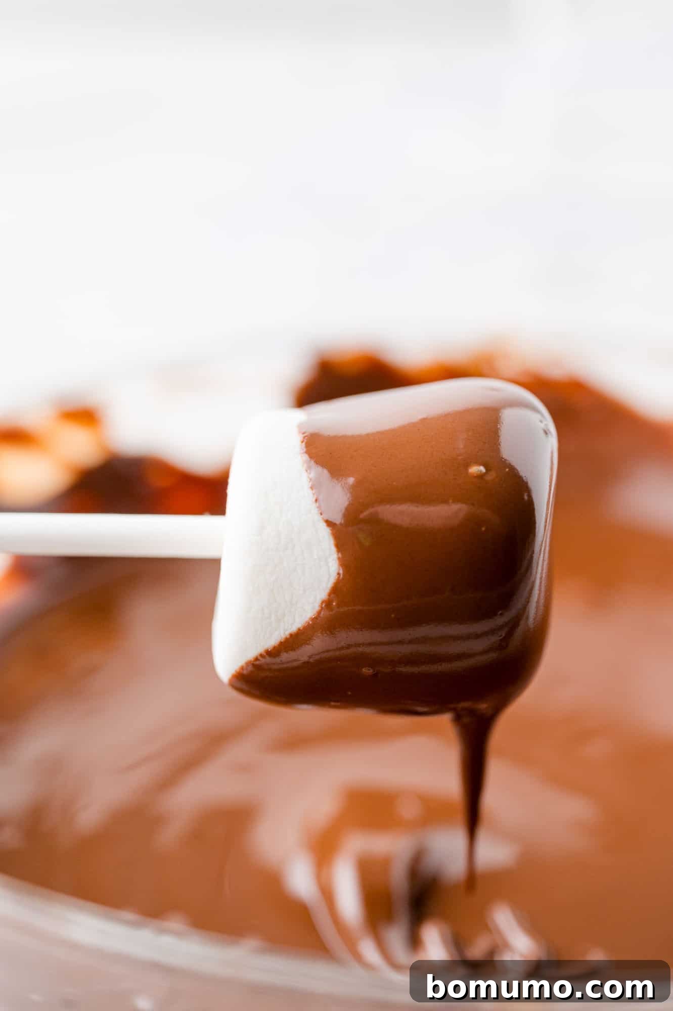 Velvet Dipped Mallows 11 Excess chocolate dripping smoothly off a freshly dipped marshmallow.