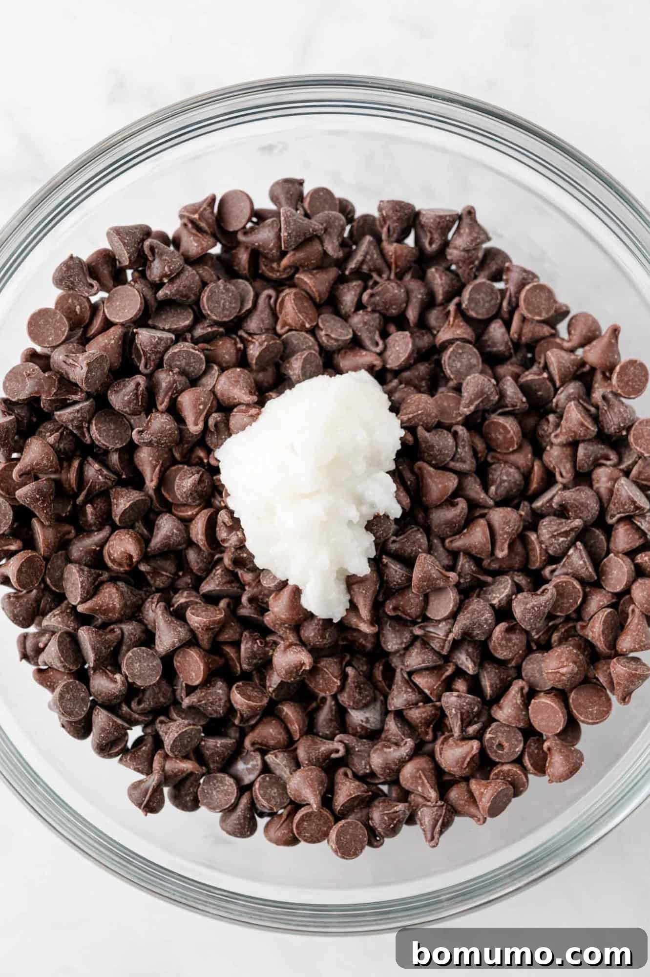 Velvet Dipped Mallows 8 Chocolate chips and coconut oil in a bowl, before melting.