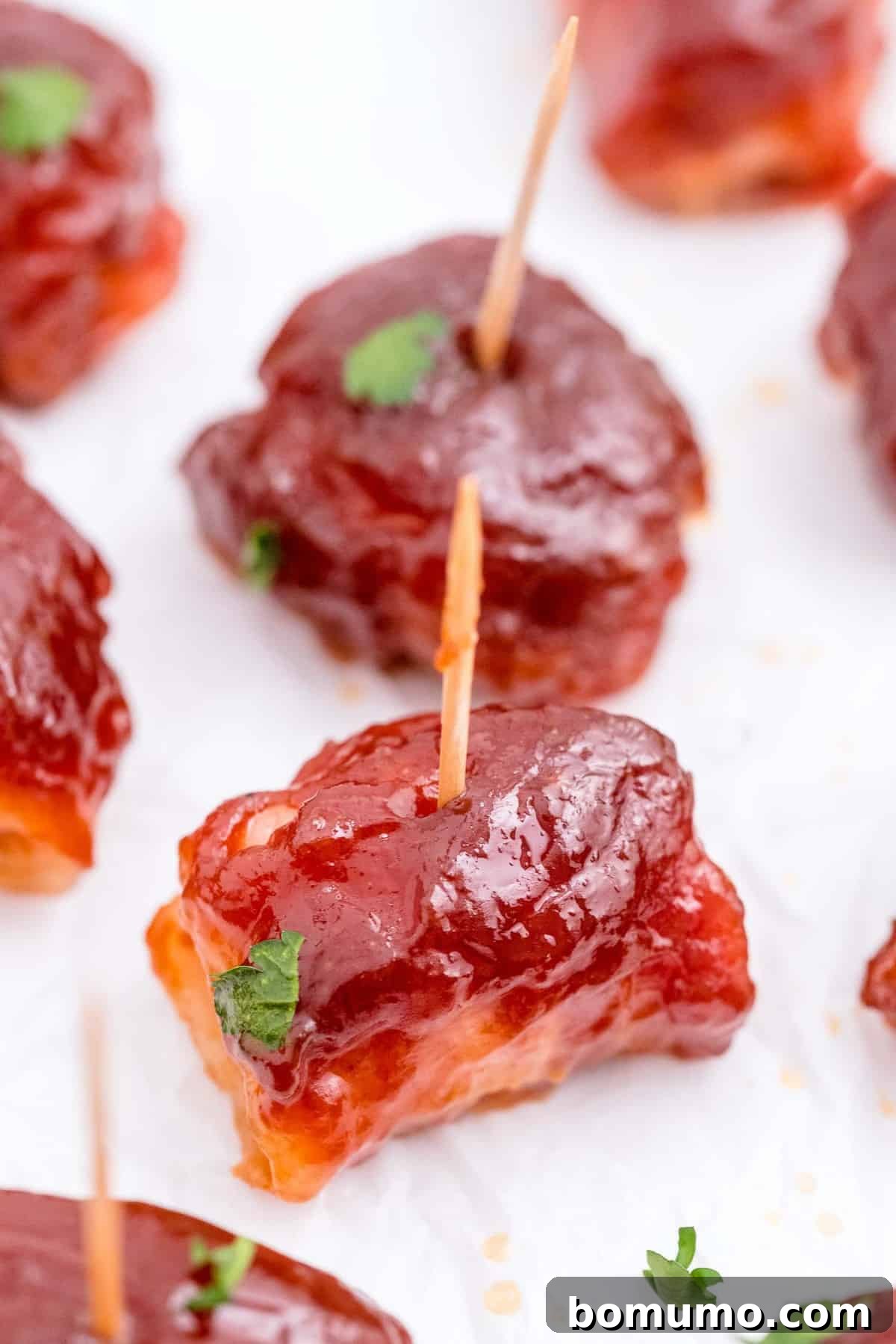 Crispy bacon-wrapped water chestnuts arranged neatly on a pristine white serving platter, ready to be enjoyed.