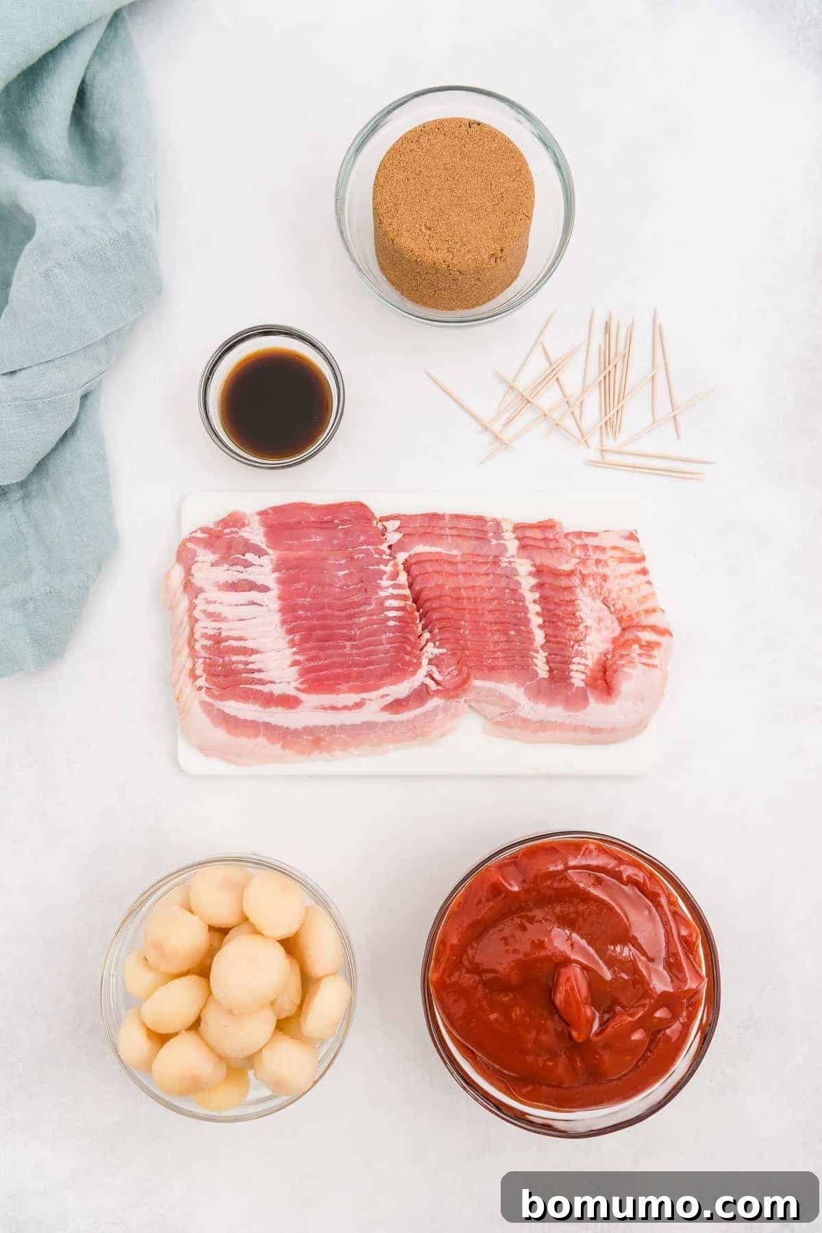An overhead shot showcasing the five core ingredients: crispy bacon, whole water chestnuts, rich ketchup, sweet brown sugar, and savory Worcestershire sauce.