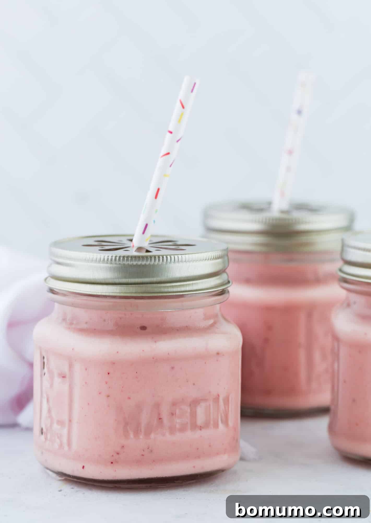 Island Escape Smoothie 5 Smoothies in small jars with lids, neatly arranged for storage or a grab-and-go meal.