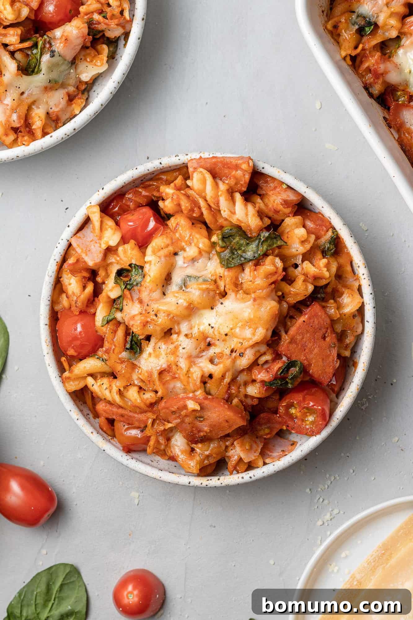 An inviting overhead view of a perfectly portioned round plate filled with the golden-brown pizza pasta, garnished with fresh herbs, ready to be enjoyed.